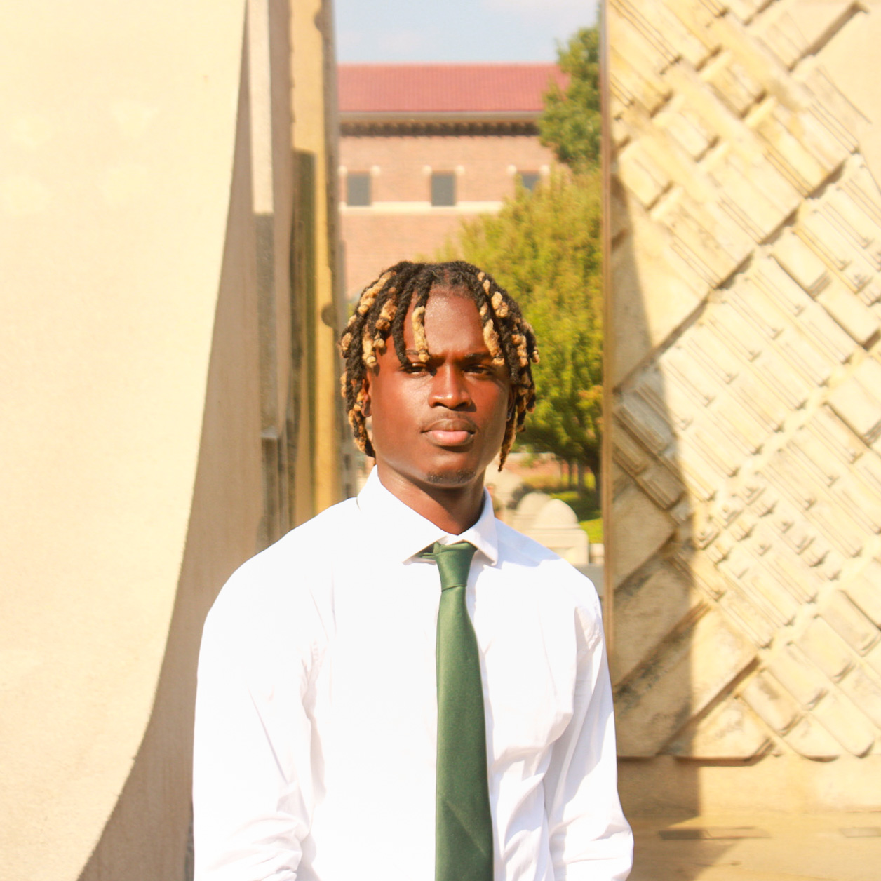 National Society of Black Engineers member standing infront of the Purdue Fountain