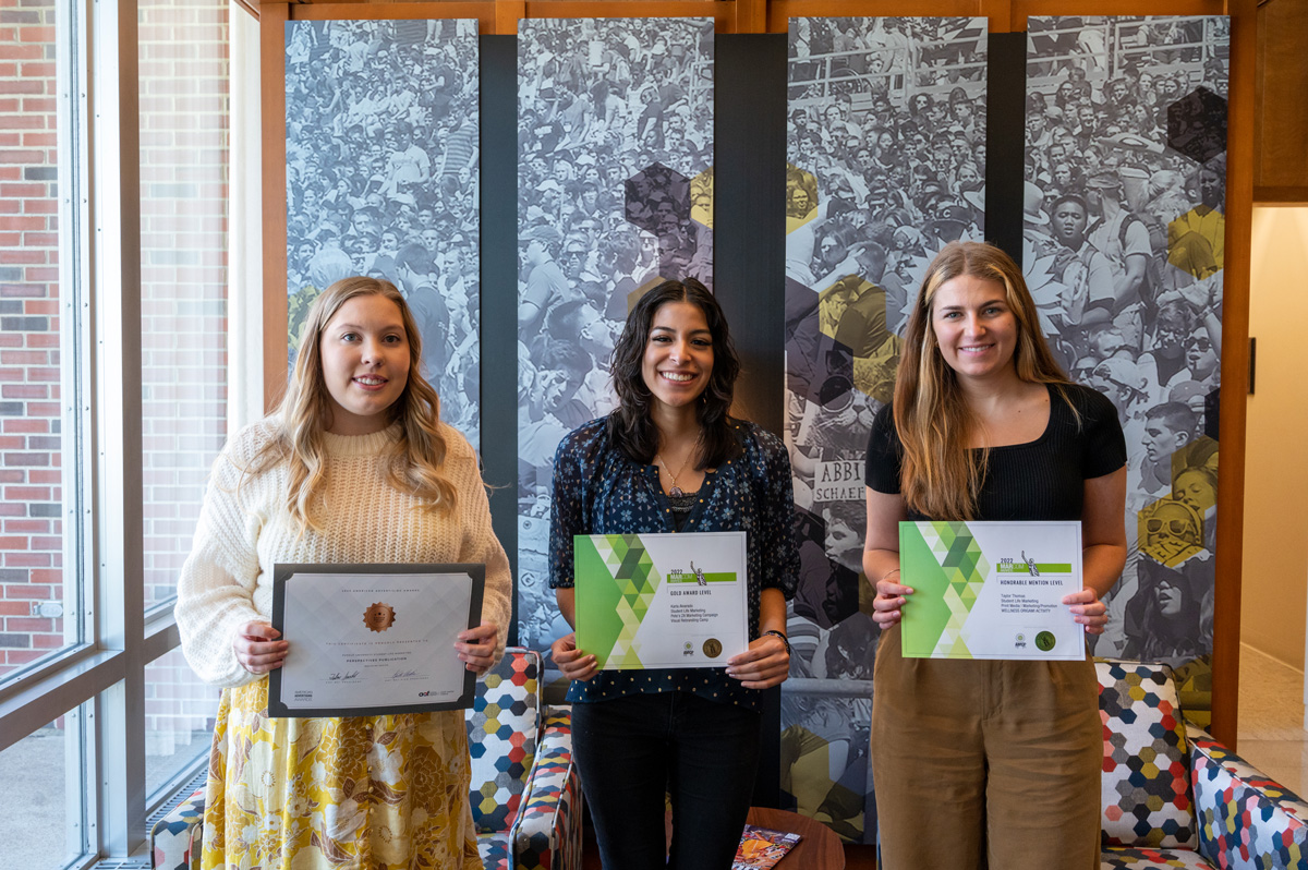 Kayla Clark, Karla Alvarado and Taylor Thomas standing with their ADDY Awards